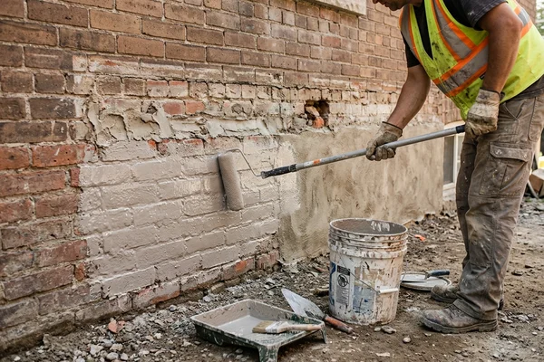 Acrylic bonding membrane applied to a prepared foundation wall