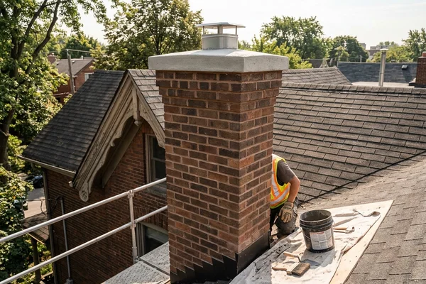 After: Straight rebuilt chimney with new crown and matched brick