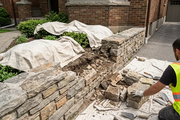 Before: Collapsed natural stone garden wall