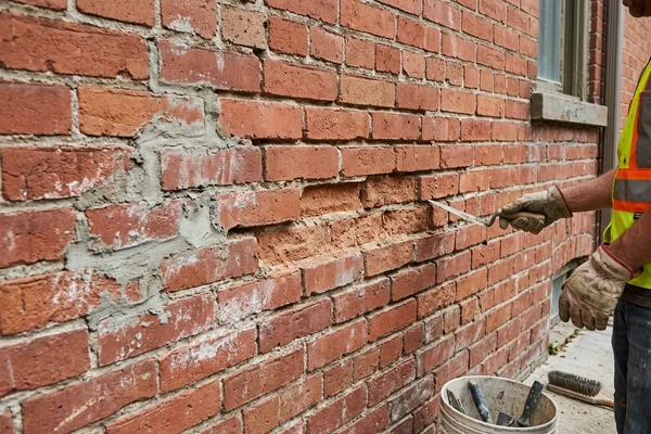 Before: Recessed joints with grey cement patches