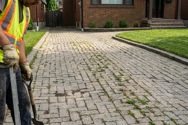 Before: Sunken, weedy interlock driveway