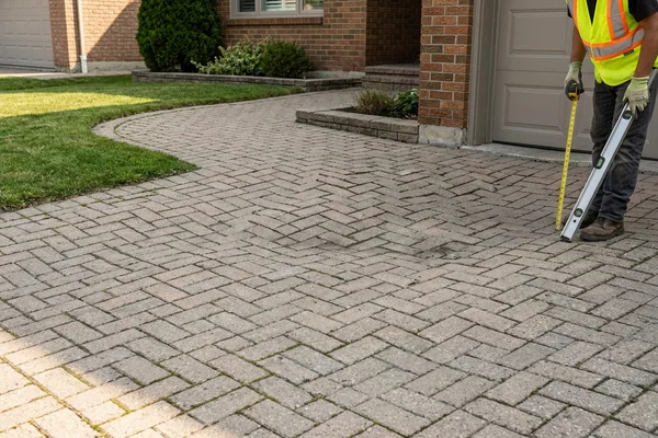 Before: Sunken uneven interlock driveway