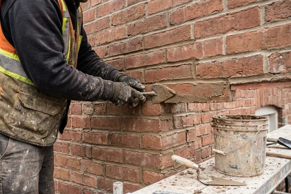 Concave tooled joints on a repointed modern brick wall
