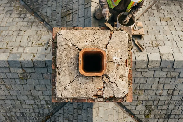 Drone inspection view of a cracked chimney crown on a Toronto roof