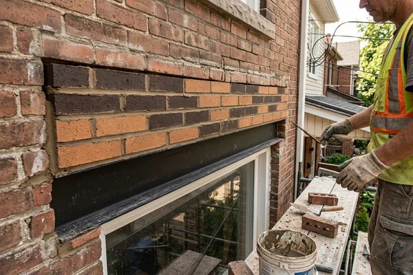 New steel lintel and rebuilt brick over a window opening