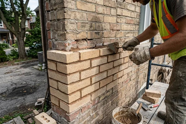 Replacement buff bricks blended into a Toronto wall