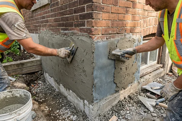 Scratch coat with fiberglass mesh on a foundation wall